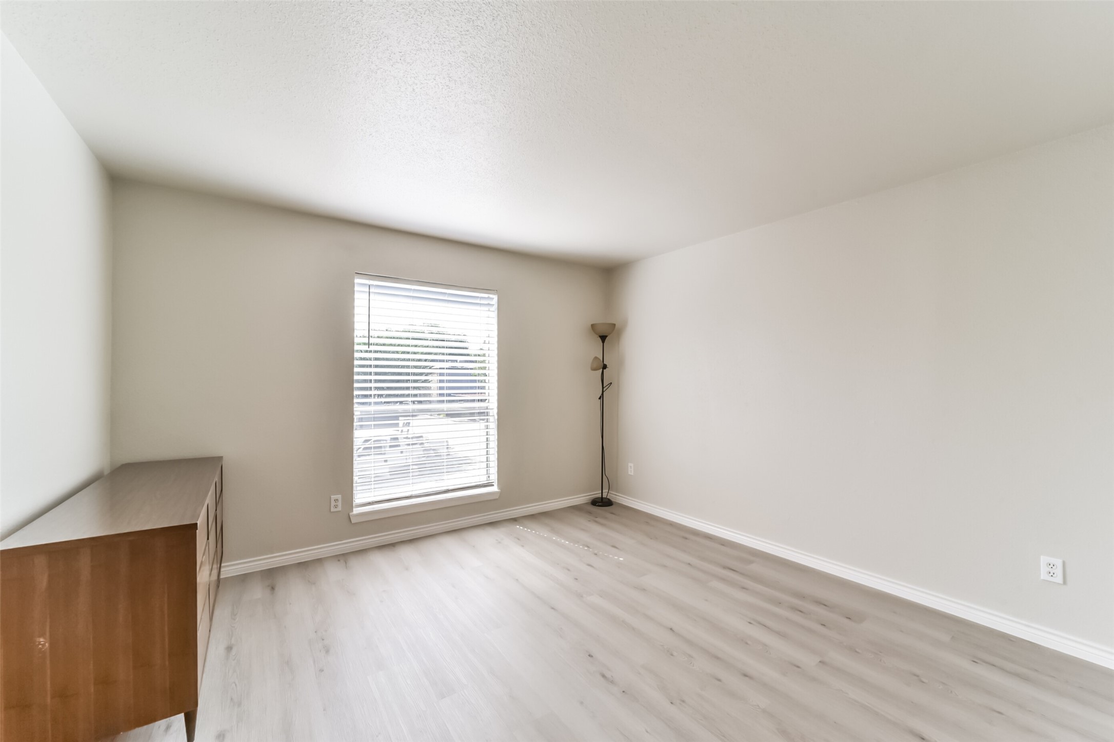 6202 Skyline Drive, Unit 44 Houston, TX 77057 - Photo 16 of 29 an empty room with wooden floor and window