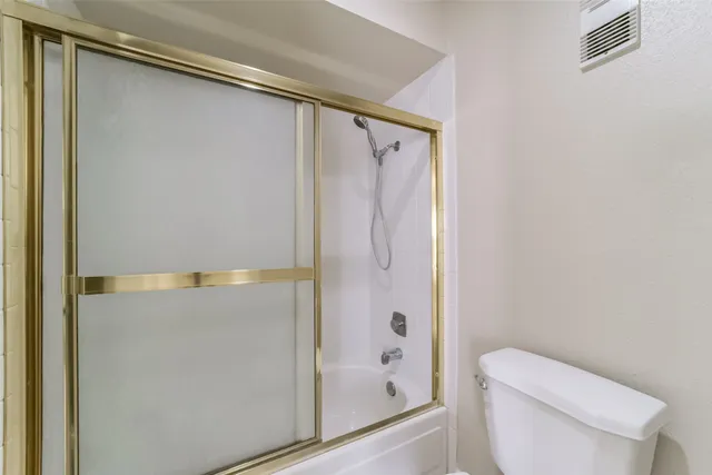 a bathroom with a shower and a toilet