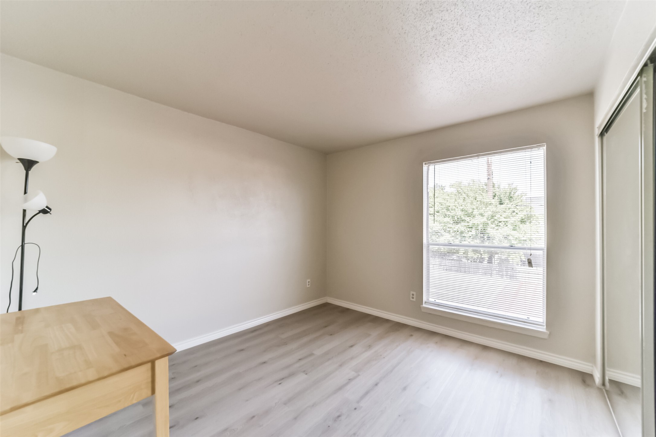 6202 Skyline Drive, Unit 44 Houston, TX 77057 - Photo 22 of 29 an empty room with wooden floor and windows