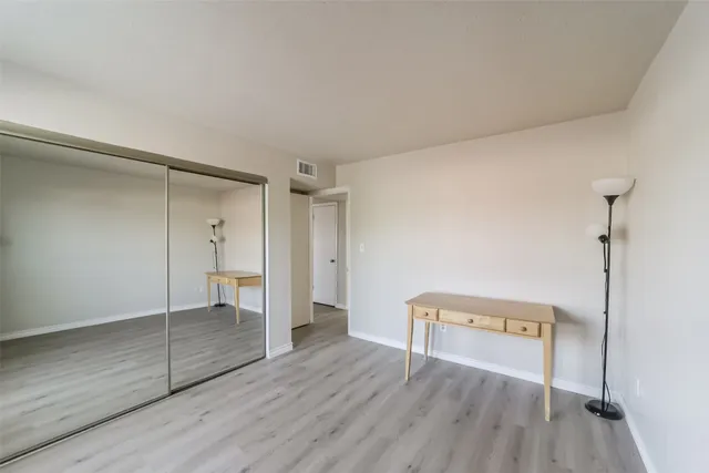 a view of a room with wooden floor