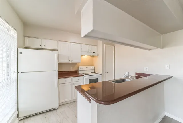 a kitchen with refrigerator and stove