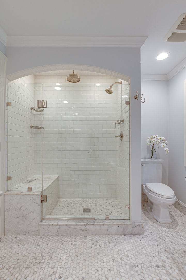 1199 Edgewood Road Lake Forest, IL 60045 - Photo 14 of 36 a bathroom with a shower a toilet and a glass door