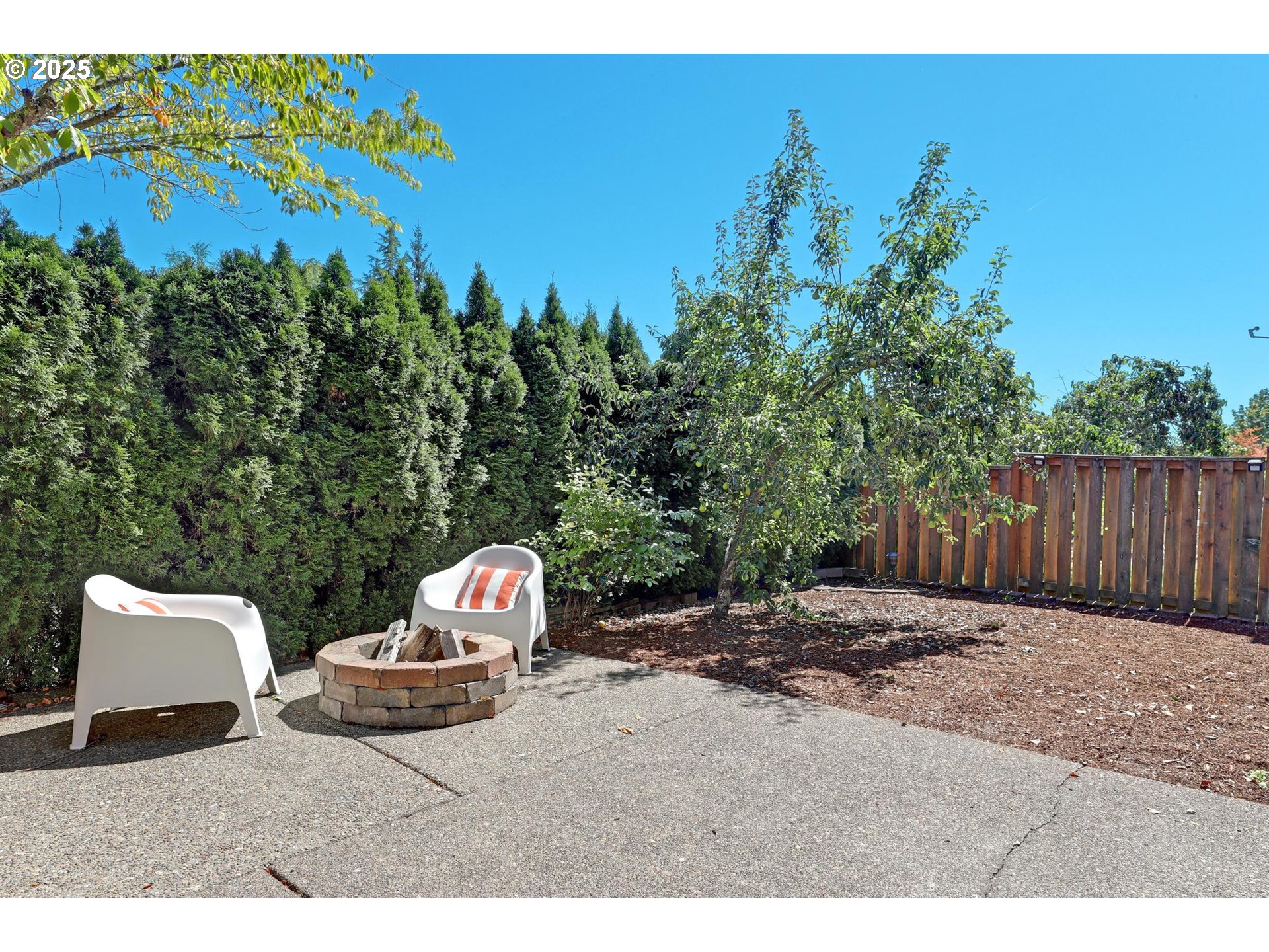 3816 Northwest Tustin Ranch Drive Portland, OR 97229 - Photo 26 of 28 a backyard of a house with table and chairs