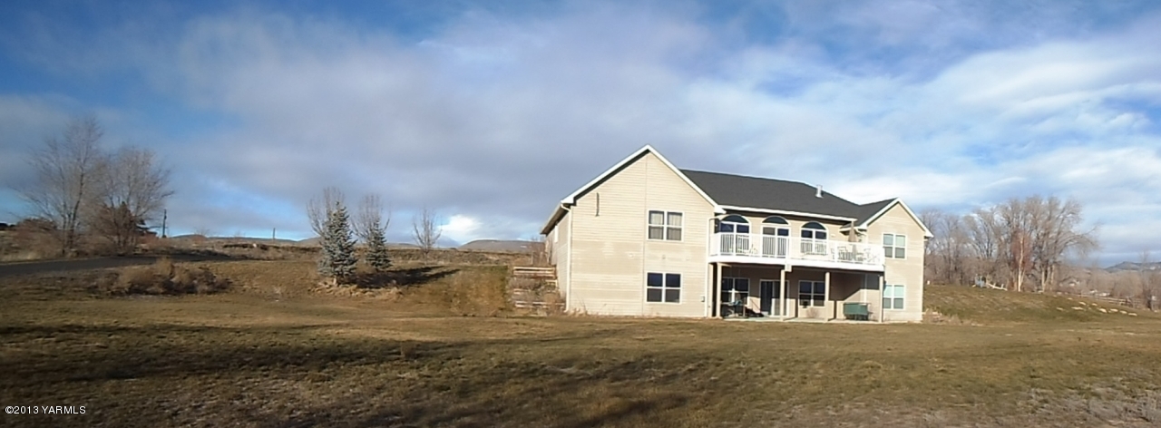 9721 Mieras Road Yakima, WA 98901 - Photo 3 of 34 a view of a large white house next to a yard