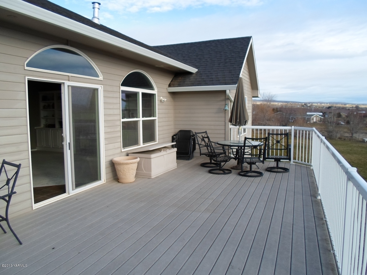 9721 Mieras Road Yakima, WA 98901 - Photo 22 of 34 a view of a deck with table and chairs and wooden floor