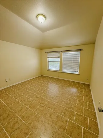 a view of an empty room with a chandeliers