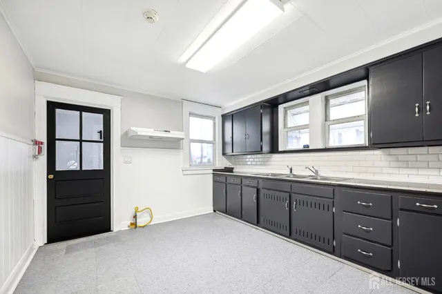 a kitchen with sink and cabinets