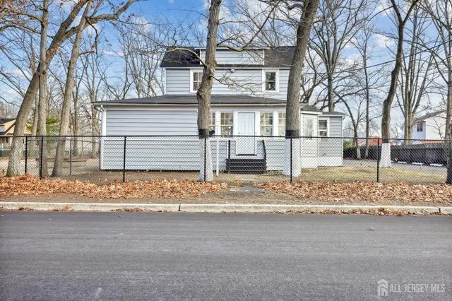 a view of a house with a yard covered in snow