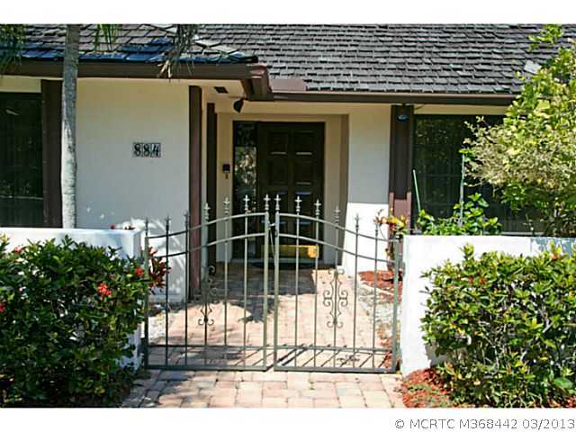 884 Northwest Spruce Ridge Drive Stuart, FL 34994 - Photo 23 of 25 Exterior Front. Gated courtyard entry