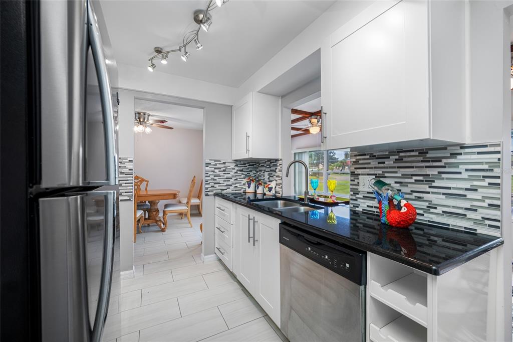 12200 Vonn Road, Unit 8A Largo, FL 33774 - Photo 17 of 41 a kitchen with stainless steel appliances granite countertop a sink and cabinets