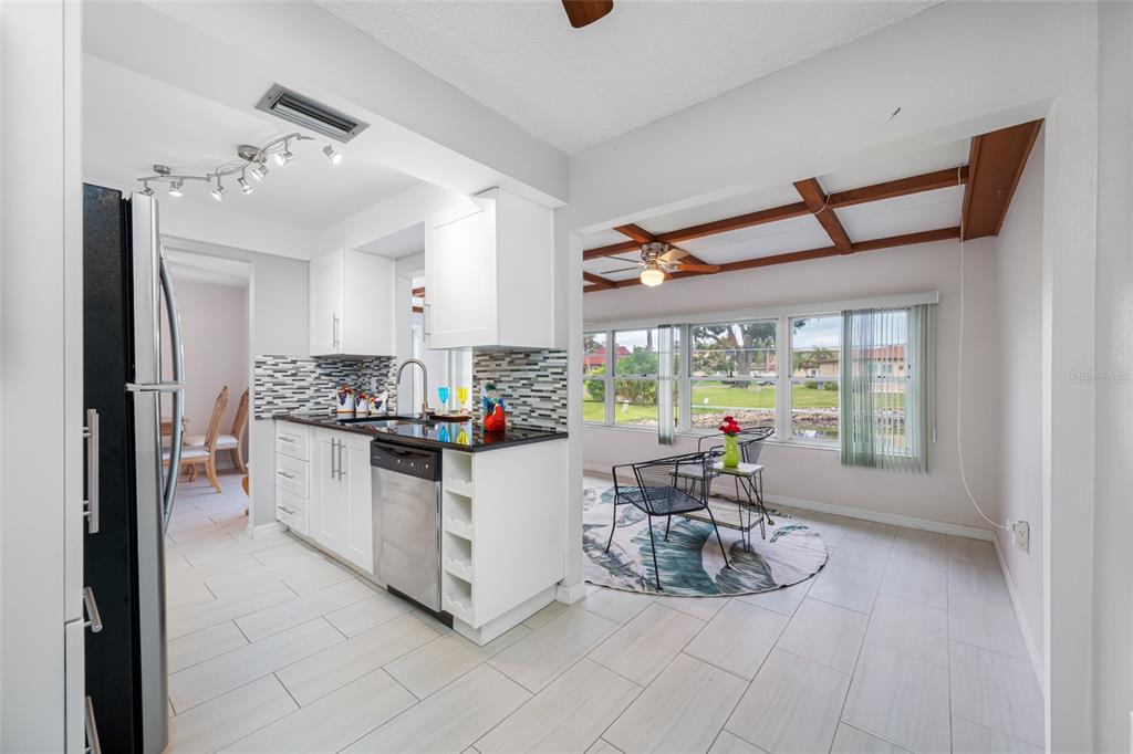 12200 Vonn Road, Unit 8A Largo, FL 33774 - Photo 19 of 41 a kitchen with white cabinets and sink