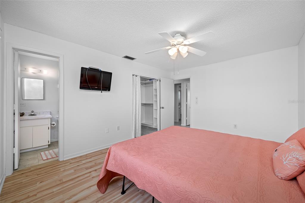 12200 Vonn Road, Unit 8A Largo, FL 33774 - Photo 23 of 41 a bedroom with a bed and a flat screen tv