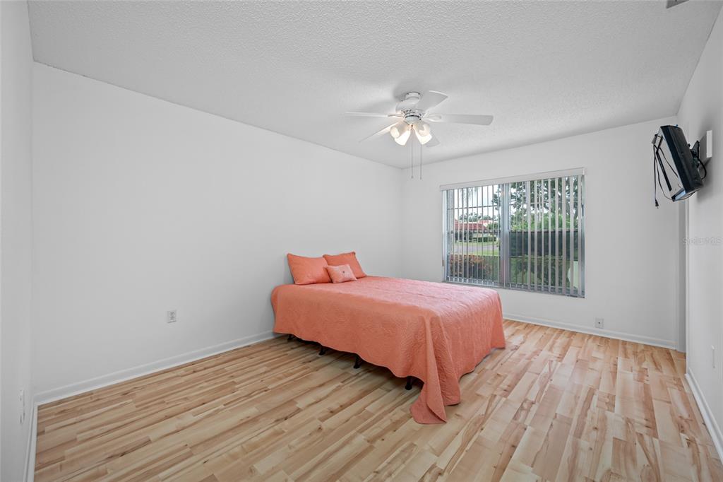12200 Vonn Road, Unit 8A Largo, FL 33774 - Photo 24 of 41 a spacious bedroom with a bed and wooden floor