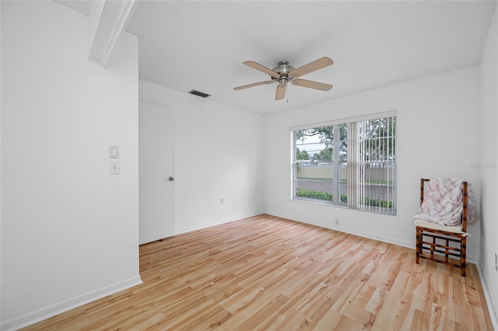 12200 Vonn Road, Unit 8A Largo, FL 33774 - Photo 26 of 41 a view of empty room with wooden floor and fan