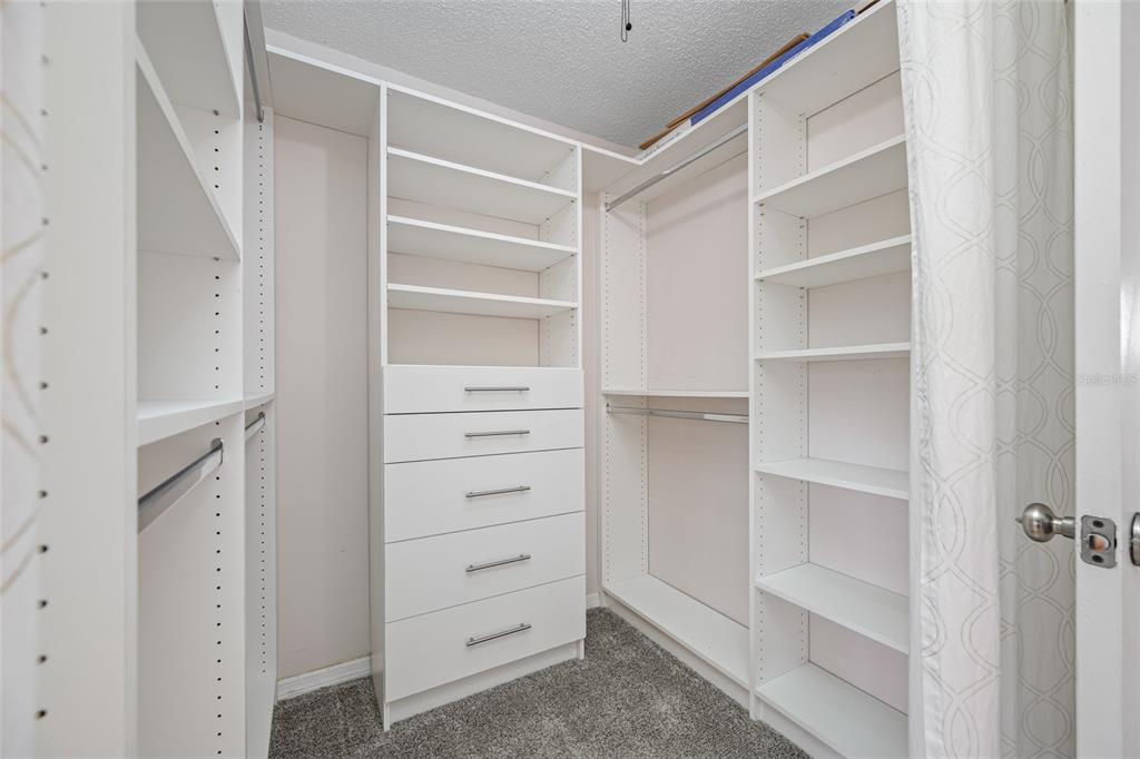 12200 Vonn Road, Unit 8A Largo, FL 33774 - Photo 29 of 41 a view of walk in closet with empty racks
