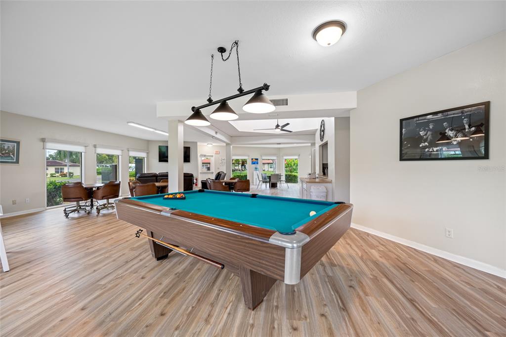 12200 Vonn Road, Unit 8A Largo, FL 33774 - Photo 34 of 41 a room with wooden floor pool table and windows