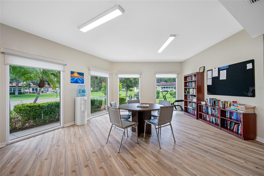 12200 Vonn Road, Unit 8A Largo, FL 33774 - Photo 35 of 41 a living room with furniture a flat screen tv and a floor to ceiling window