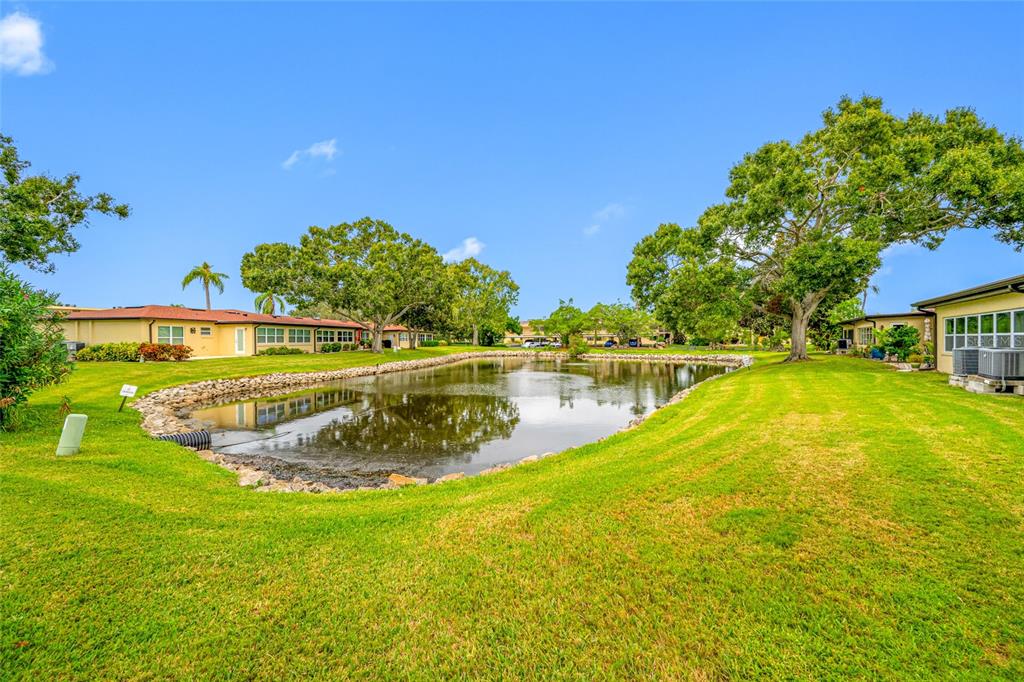 12200 Vonn Road, Unit 8A Largo, FL 33774 - Photo 6 of 41 a view of a swimming pool with a yard