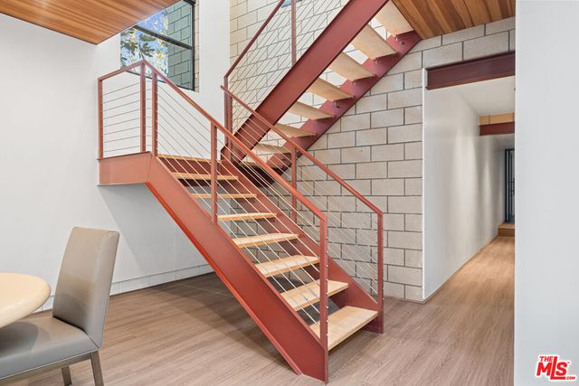 a view of staircase with wooden floor and chair