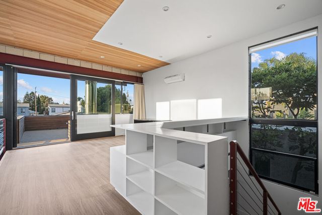 a view of a kitchen with a sink and wooden floor