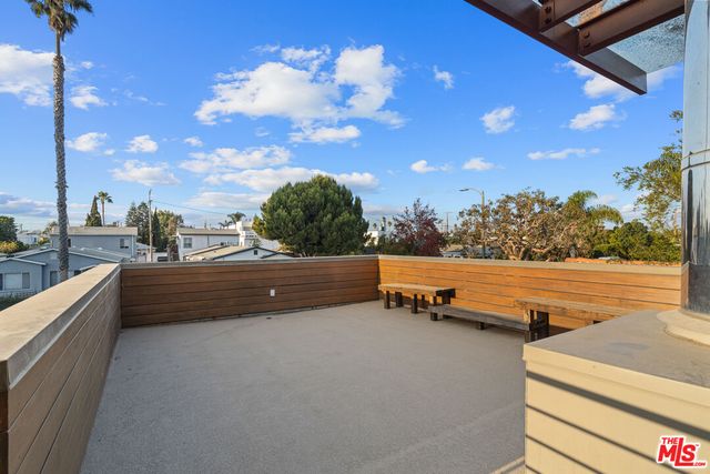 a view of city and swimming pool with outdoor seating
