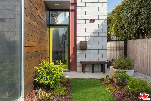 a potted plant sitting in front of a house