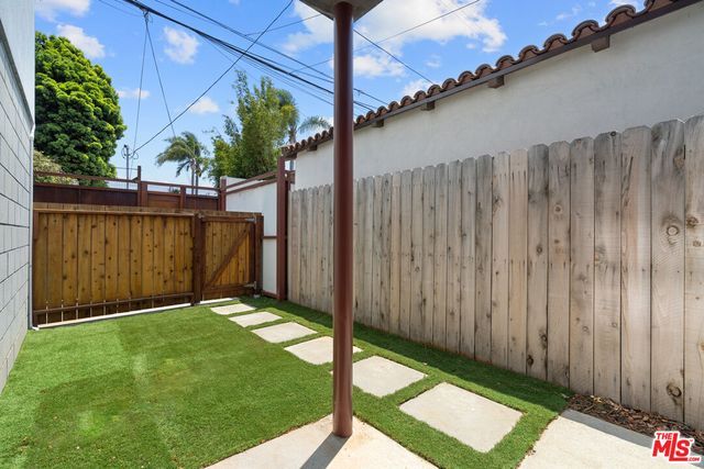 a view of a backyard with a fence