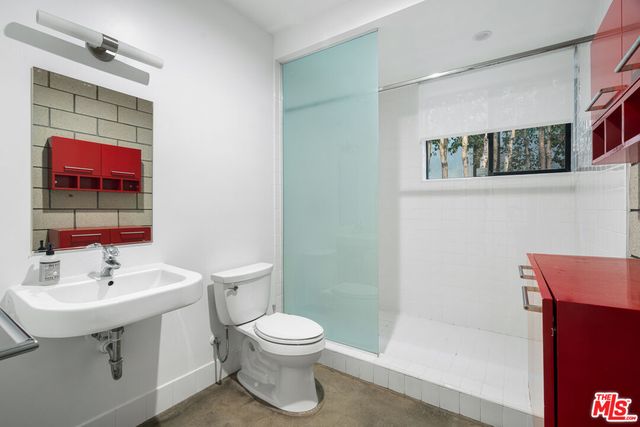 a bathroom with a sink a mirror and a toilet