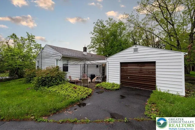 a view of a house with a yard and a garden