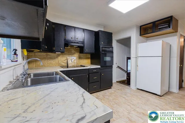 a kitchen with sink refrigerator and microwave