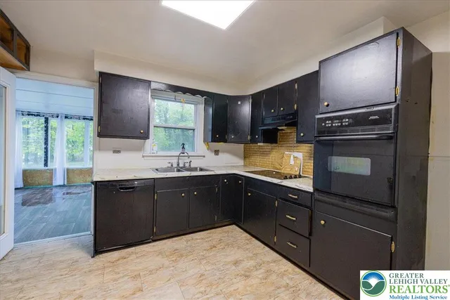 a kitchen with a sink stove and refrigerator