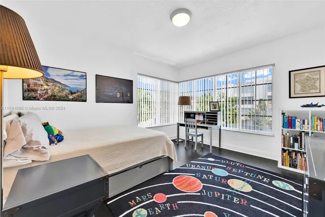 a bedroom with a bed and a dresser in it