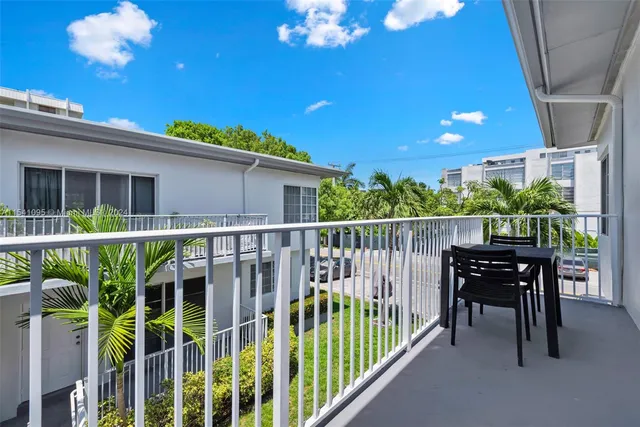 a view of a house with a porch and furniture