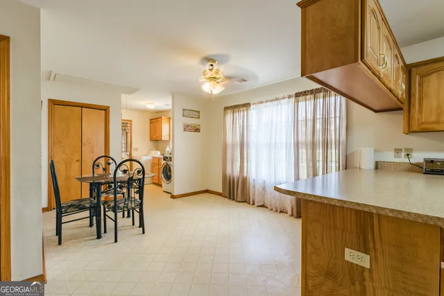 a kitchen with stainless steel appliances granite countertop a refrigerator a sink and a stove
