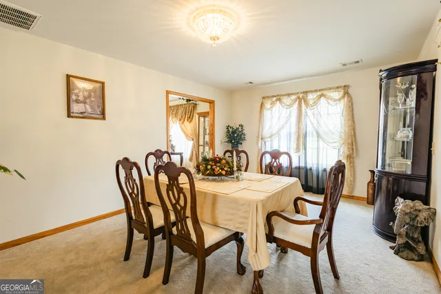 a view of a dining room with furniture window and outside view