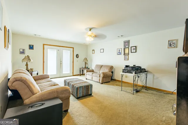 a living room with furniture a chandelier and a flat screen tv