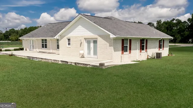 a front view of a house with a garden and yard