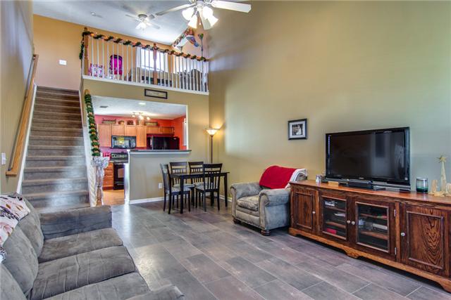 424 Creekside Lane Spring Hill, TN 37174 - Photo 2 of 20 The Living Room has Great Laminate Wood Floors and is Open to the Kitchen and Dining Room with a 2 Story Cathedral Ceiling to the Upstairs Loft.