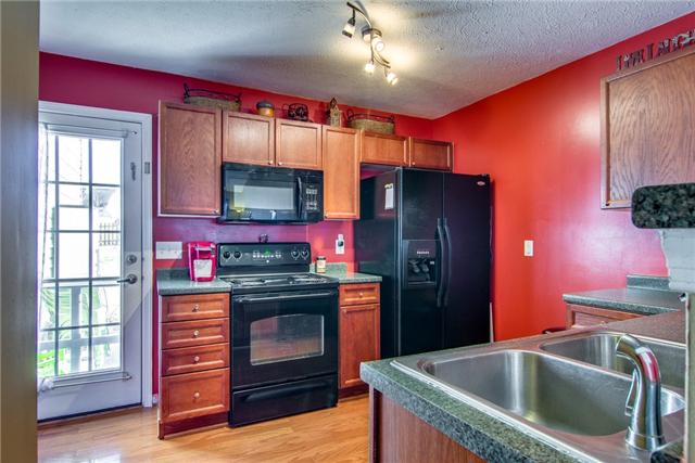 424 Creekside Lane Spring Hill, TN 37174 - Photo 5 of 20 The Kitchen Features Updated Lighting and all Black Appliances. The Refrigerator is Negotiable.