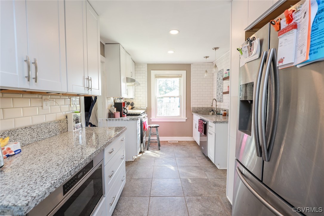 10432 Verdon Road Doswell, VA 23047 - Photo 9 of 30 a kitchen with a refrigerator and a sink