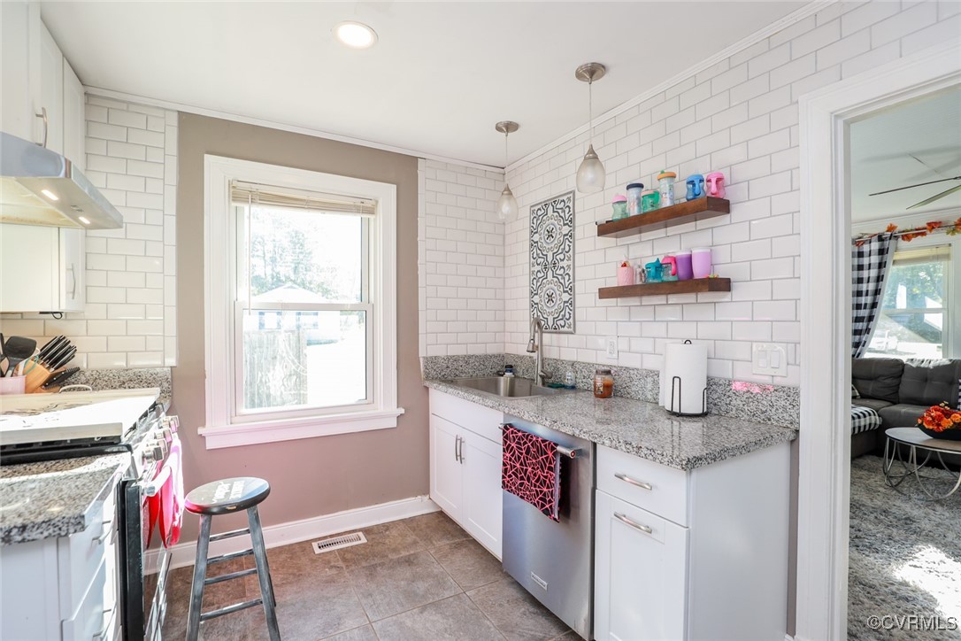 10432 Verdon Road Doswell, VA 23047 - Photo 10 of 30 a kitchen with granite countertop a sink stove and cabinets