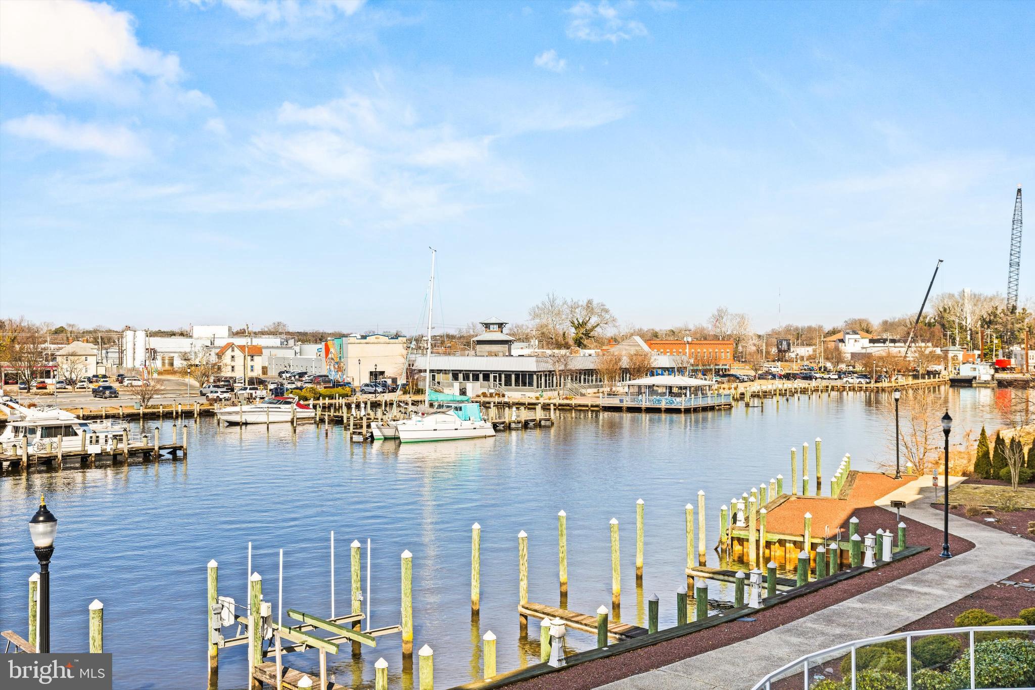 530 Riverside Drive, Unit 202 Salisbury, MD 21801 - Photo 12 of 38 a view of a lake with boats and trees in the background