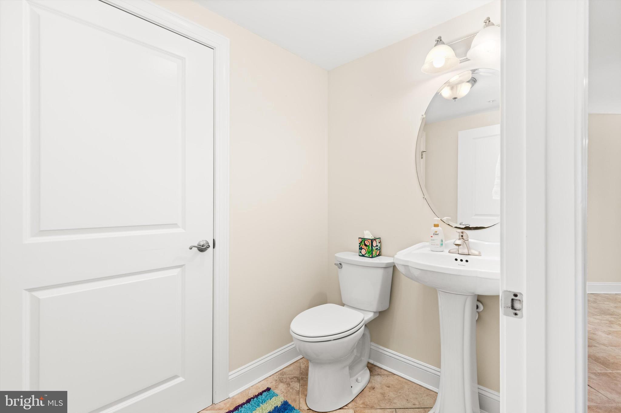 530 Riverside Drive, Unit 202 Salisbury, MD 21801 - Photo 22 of 38 a bathroom with a toilet a sink and mirror