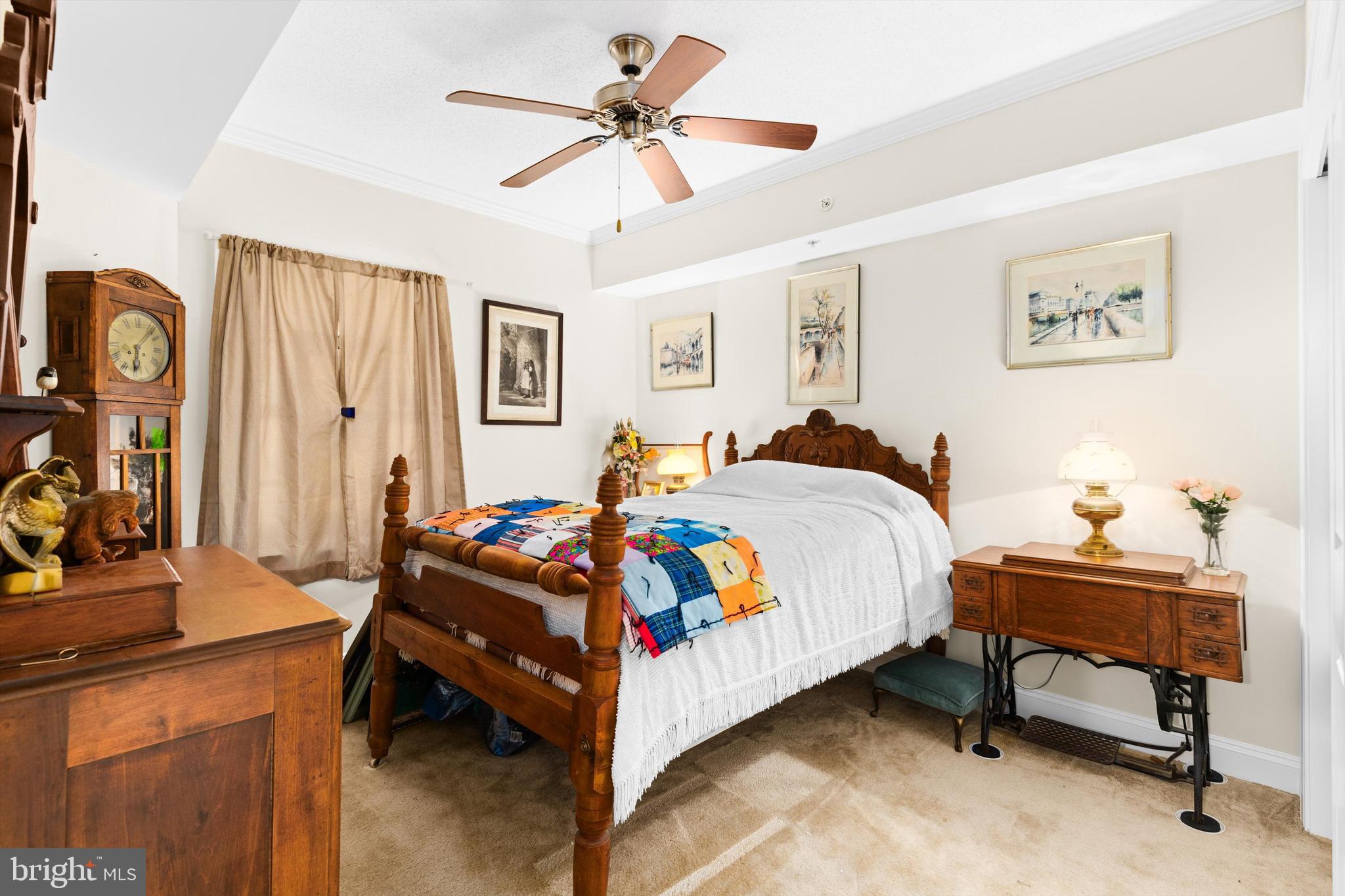 530 Riverside Drive, Unit 202 Salisbury, MD 21801 - Photo 26 of 38 a bedroom with a bed and a chandelier