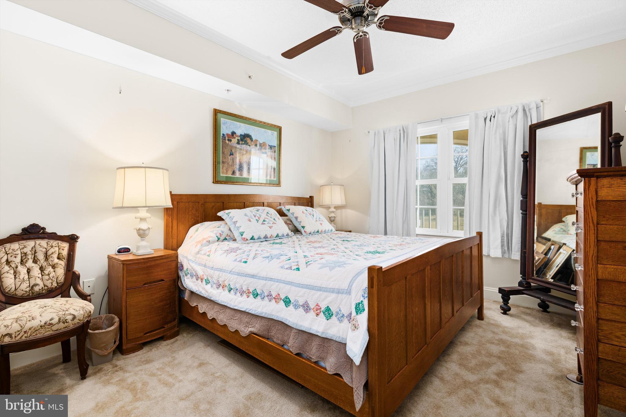530 Riverside Drive, Unit 202 Salisbury, MD 21801 - Photo 28 of 38 a bedroom with a bed and a chandelier