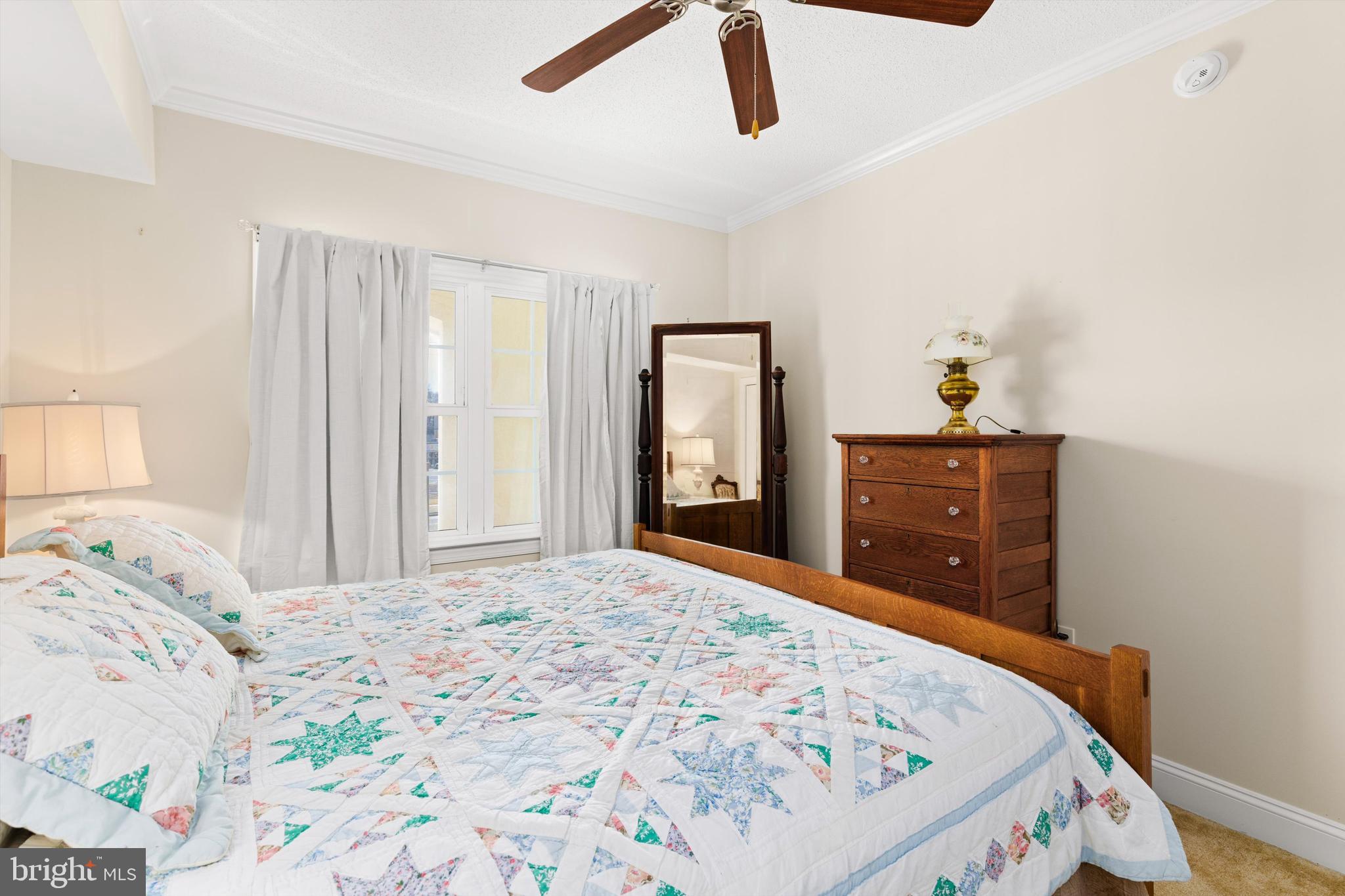 530 Riverside Drive, Unit 202 Salisbury, MD 21801 - Photo 29 of 38 a bedroom with a bed and a dresser