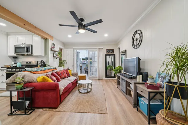 a bedroom with a bed a dresser and a large mirror