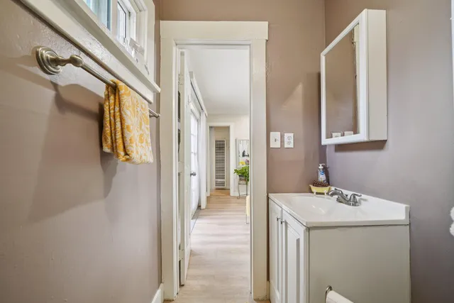 a view of a house with a yard and potted plants
