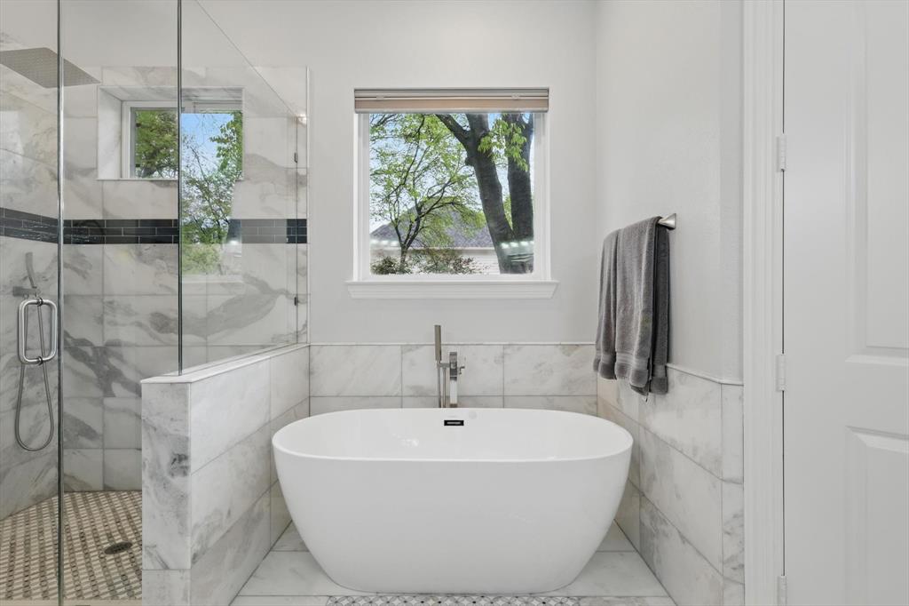 8517 Stallion Street Denton, TX 76208 - Photo 18 of 36 a white bath tub sitting next to a shower