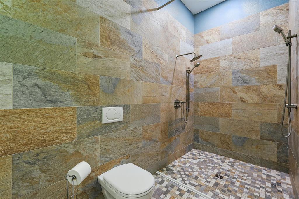 8517 Stallion Street Denton, TX 76208 - Photo 20 of 36 a bathroom with a toilet and a shower